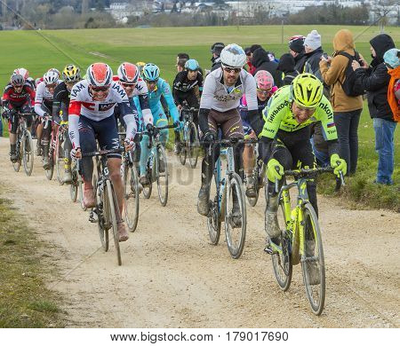 VendomeFrance- March 72016:The cyclists rinding in the peloton on a dirty roadTertre de la Motte in Vendome during the first stage of Paris-Nice 2016.