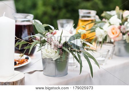 Wedding bouquet of yellow and white roses and blue fresia lying on wooden floor.