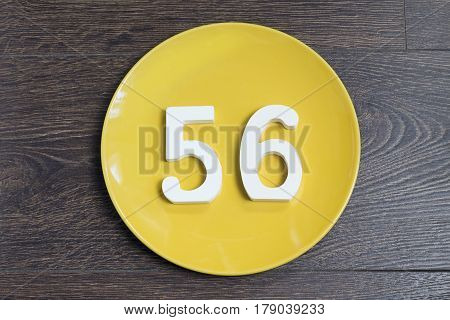 The number fifty-six on the plate yellow and brown background.