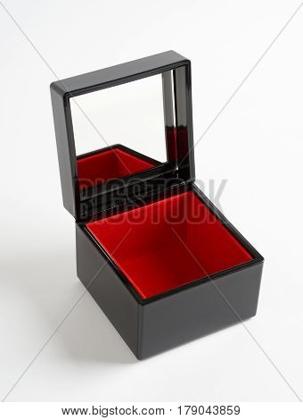 Black plastic glossy gift box with mirrow and red bottom isolated on white