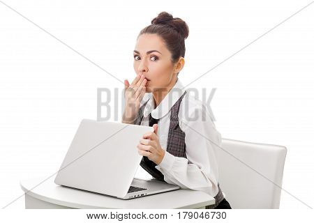Image of young employer looking at laptop with surprise in office. Business and office concept surprised businesswoman using her laptop computer. Woman looking at camera against isolated white background