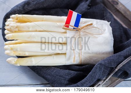 Fresh spring Dutch AA white asparagus ready to cook on wooden backgroung close up