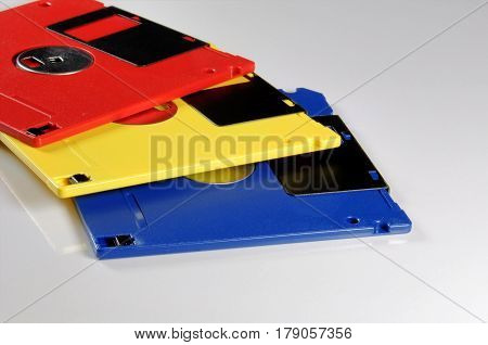 Old color floppy disk. Red yellow and blue.