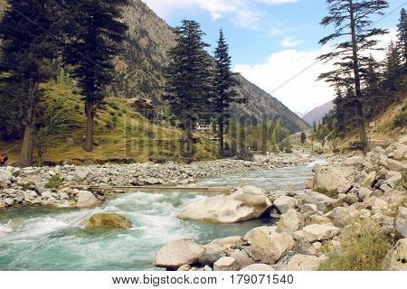 Beautiful river in the mountains with blue skys pure green water and trees in swat valley kpk Pakistan