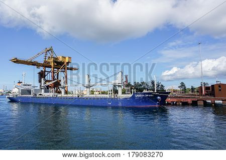 Labuan,Malaysia-Mac 25,2017:A large bulk carrier supplying iron ore in Antara Steel Mill Plant port at Labuan,Malaysia.The company produces billets and bars including angle bars and U-channels.