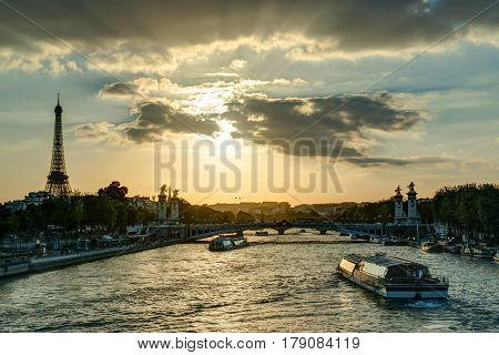 The River Seine with the Eiffel tower at sunset in Paris, France