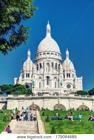 PARIS - SEPTEMBER 24: Tourists visiting the Basilica of the Sacred Heart(Basilique du Sacre-Coeur) on september 24, 2013. A popular landmark the basilica is located at the summit of the butte Montmartre the highest point in the city.
