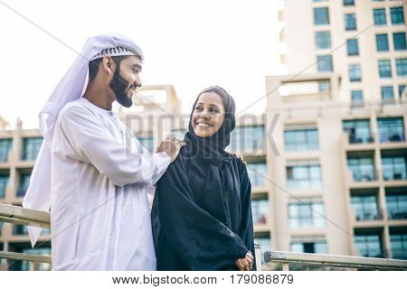 Arabic couple with traditional clothes dating outdoors