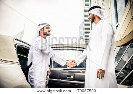 Arabic businessmen in Dubai handshaking after a business meeting