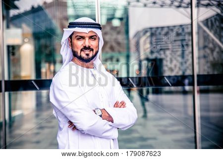 Arabic businessman in Dubai, smiling and looking at camera