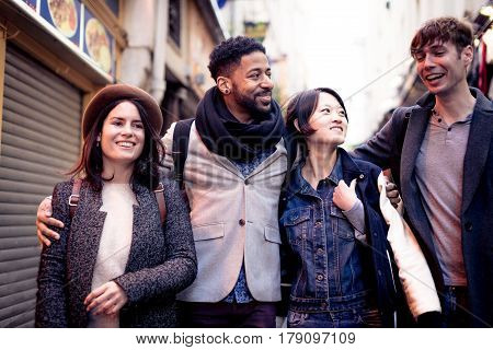 Multi-ethnic group of friends having fun in Paris, Latin Quarter, near Notre Dame Cathedral.
