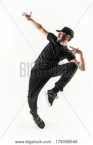 The silhouette of one young hip hop male break dancer dancing on white background