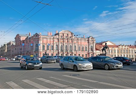 SAINT-PETERSBURG, RUSSIA, MARCH 29, 2017: City transport on the Nevsky Avenue near The Anichkov Bridge with The Horse Tamers by Peter Klodt. On the background is Beloselsky-Belozersky Palace