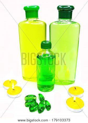 bottles of shampoo and shower gel amond candles