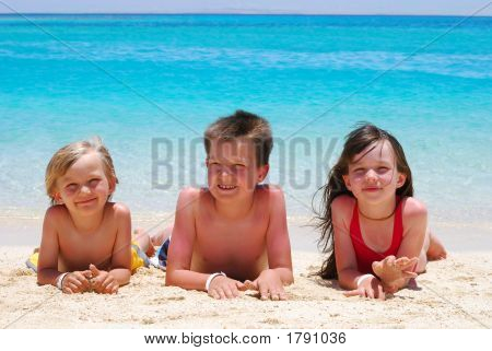 เด็ก 3 คนที่นอนอยู่บนชายหาด
