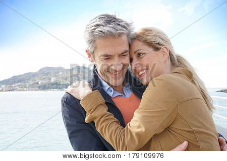 Middle-aged couple embracing each other by the sea, San Sebastian