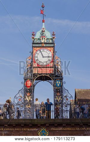 Chester England UK - March 25 2017: The ornate wrought iron Eastgate Clock over Chester's east gate a prominent city landmark built to celebrate the diamond jubilee of Queen Victoria in 1897