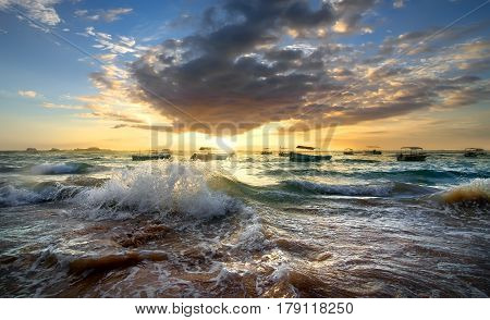 Fishing boats in the ocean at sunset