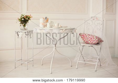 White Retro Iron Furniture With Coffee Set On The Table