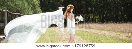 Woman In Wedding Dress In Natural Scenery