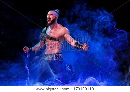 Handsome young sexy man with beautiful muscular chest in interesting costume on the scene. The Stripper man. Show time