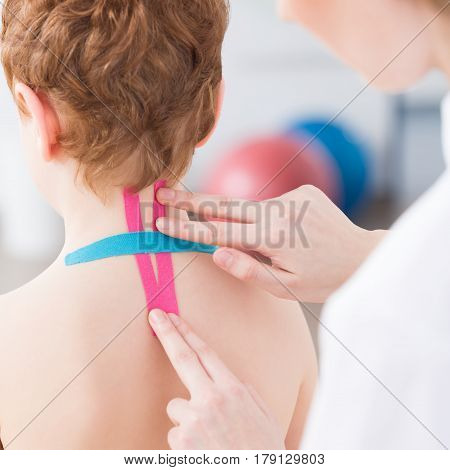 Physiotherapist Applying Kinesiology Tapes