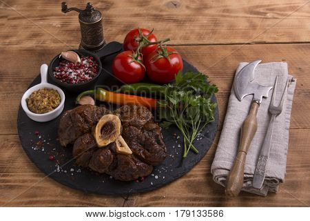 roasted meat on the bone Osso Buco on board