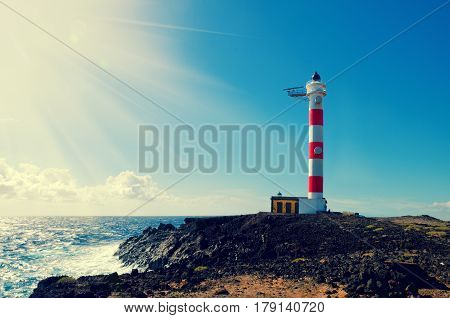 Old lighthouse in Punta de Abona beach. Landmark on the south of Tenerife Canary islands Spain.