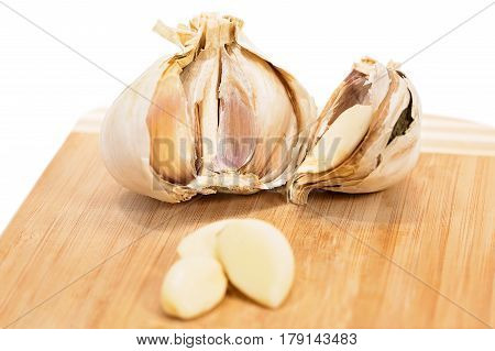 close up of garlic on wooden cutting board