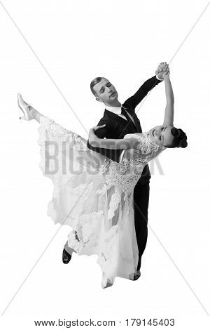 beautiful ballroom dance couple in a dance pose isolated on white background. sensual professional dancers dancing walz tango slowfox and quickstep black and white