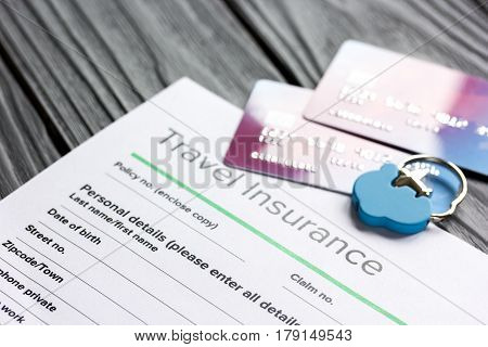 Travel preparation concept with insurance application form and credit cards for online payment on wooden table background