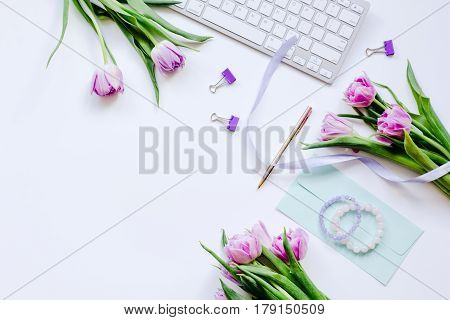 Trendy spring design of office workdesk with blossom on white background top view mock-up