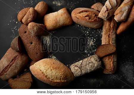 Top view of blank copy space represented among different kinds of breads. Different bread sorts for your taste. Variety of different kind of breads, food industry.