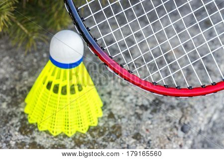 Closeup of badminton rachet and neon yellow shuttlecock sports and recreational activity background