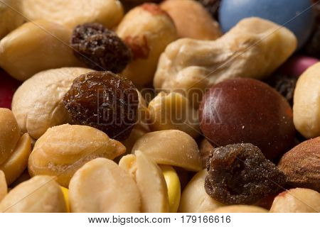 Close Up Of Pile Of Trail Mix With Nuts, Raisins, And Candy