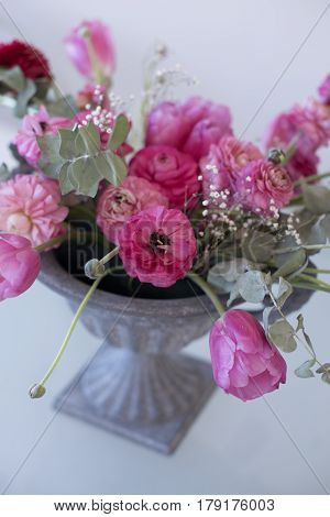 Pink Ranunculus Flower And Pink Tulips Arranged In Iron Vase