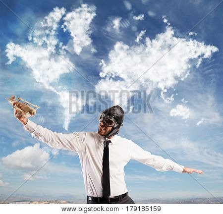 Man playing with a wooden airplane dreaming trips around the full world