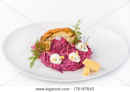 Beet salad dressed with sauce with rusks and egg in the form of mice