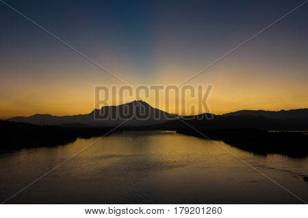 Amazing ray of light during  sunrise   behind Mount Kinabalu located at KotaKInabalu, Sabah, Malaysia