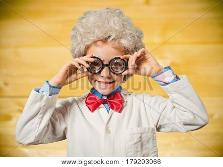 Digital composite of Boy genius against yellow wood panel