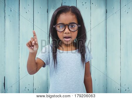 Digital composite of Girl with glasses against blue wood panel