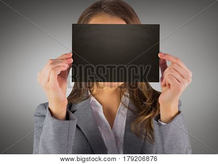 Digital composite of Business woman with black blank card over face against grey background