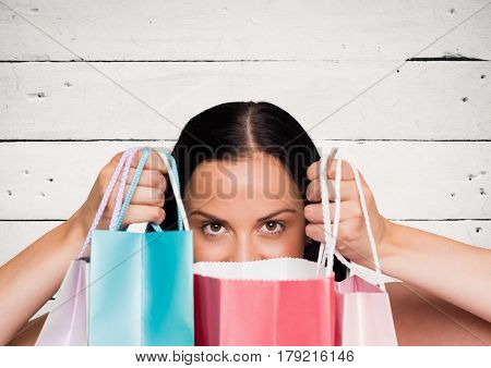 Digital composite of Woman with shopping bags against white wood panel