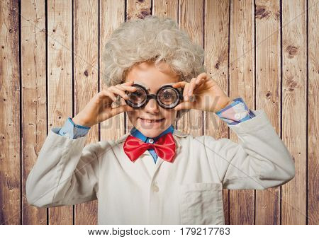 Digital composite of Boy genius costume against wood panel