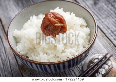 Traditional Japanese Koshihikari Rice with Umeboshi as close-up in a bowl
