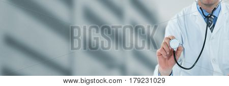 Doctor examining with stethscope against low angle view of defocused building