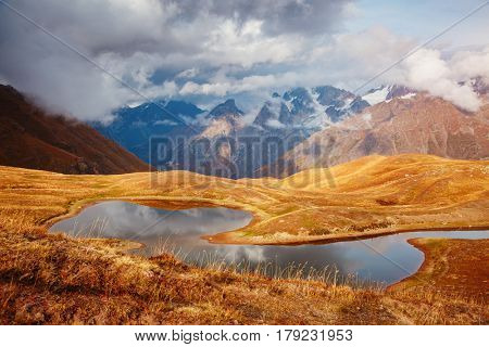 A look at the main Caucasus ridge and Koruldi lake. Picturesque day and gorgeous scene. Location Mestia, Upper Svaneti, Georgia country, Europe. Unique place on earth. Explore the world's beauty.