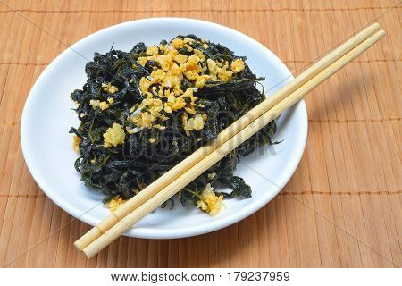 Chinese Traditional Food, Stir Fried Jute Leaves or Mulukhiyah Leaves with Garlics and Fermented Soy Bean.