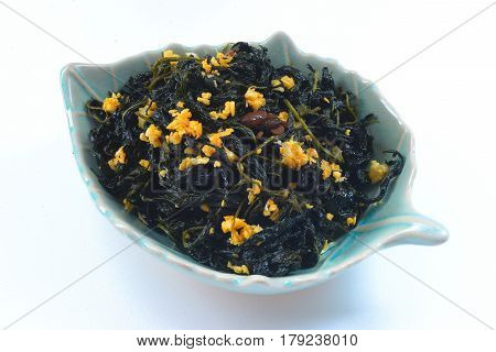 Chinese Traditional Food, Stir Fried Jute Leaves or Mulukhiyah Leaves with Garlics and Fermented Soy Bean.