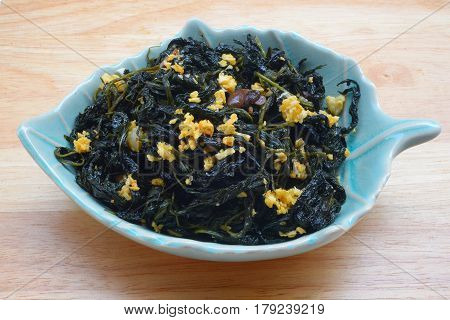 Chinese Traditional Food, Stir Fried Jute Leaves or Mulukhiyah Leaves with Garlics and Fermented Soy Bean.